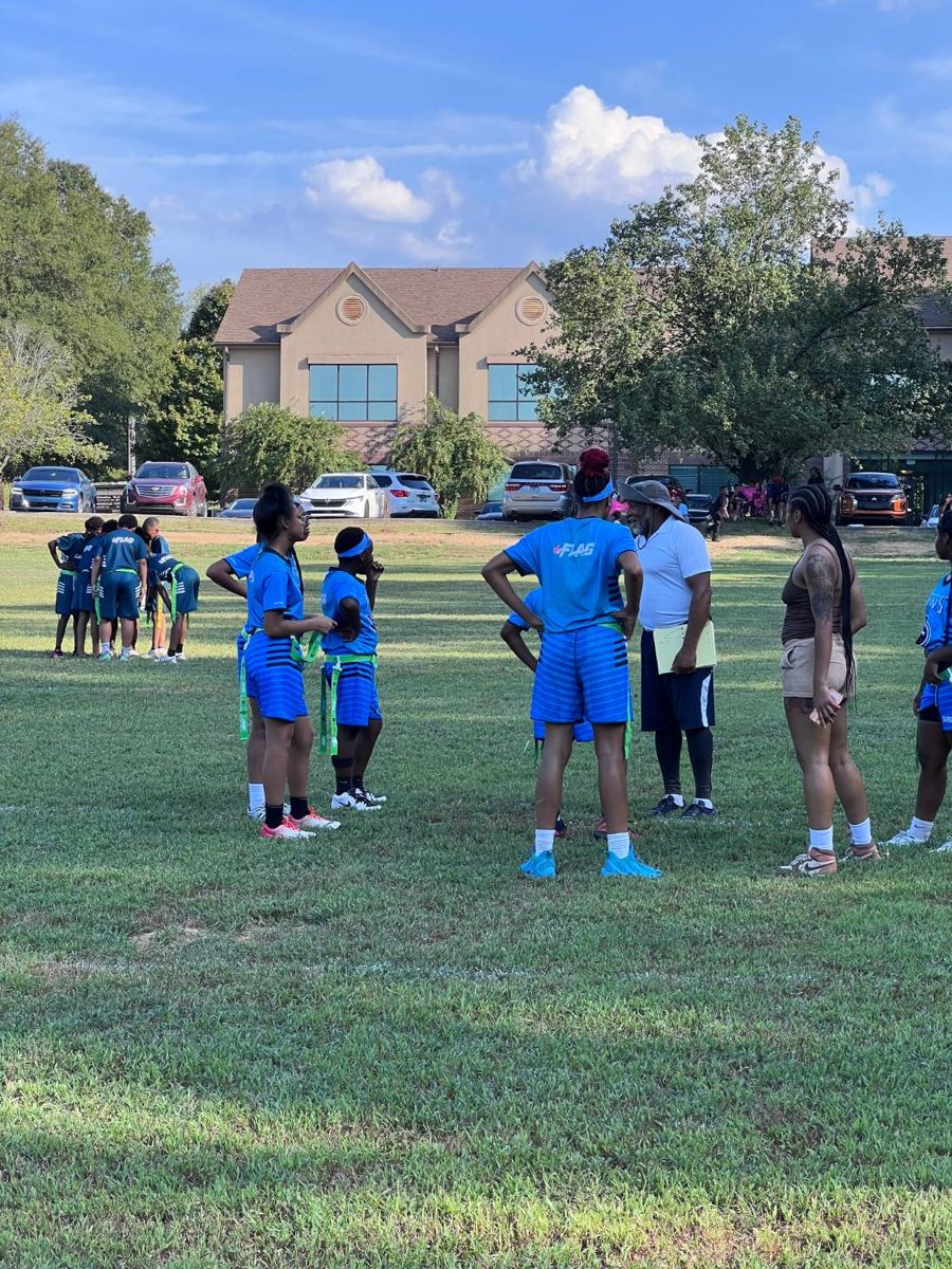 Coach talking with players on the field