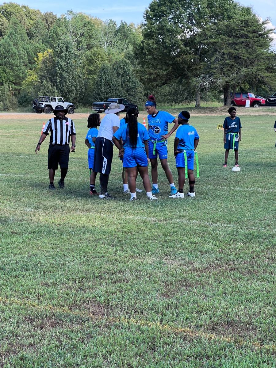 Team huddle with the coach and referee