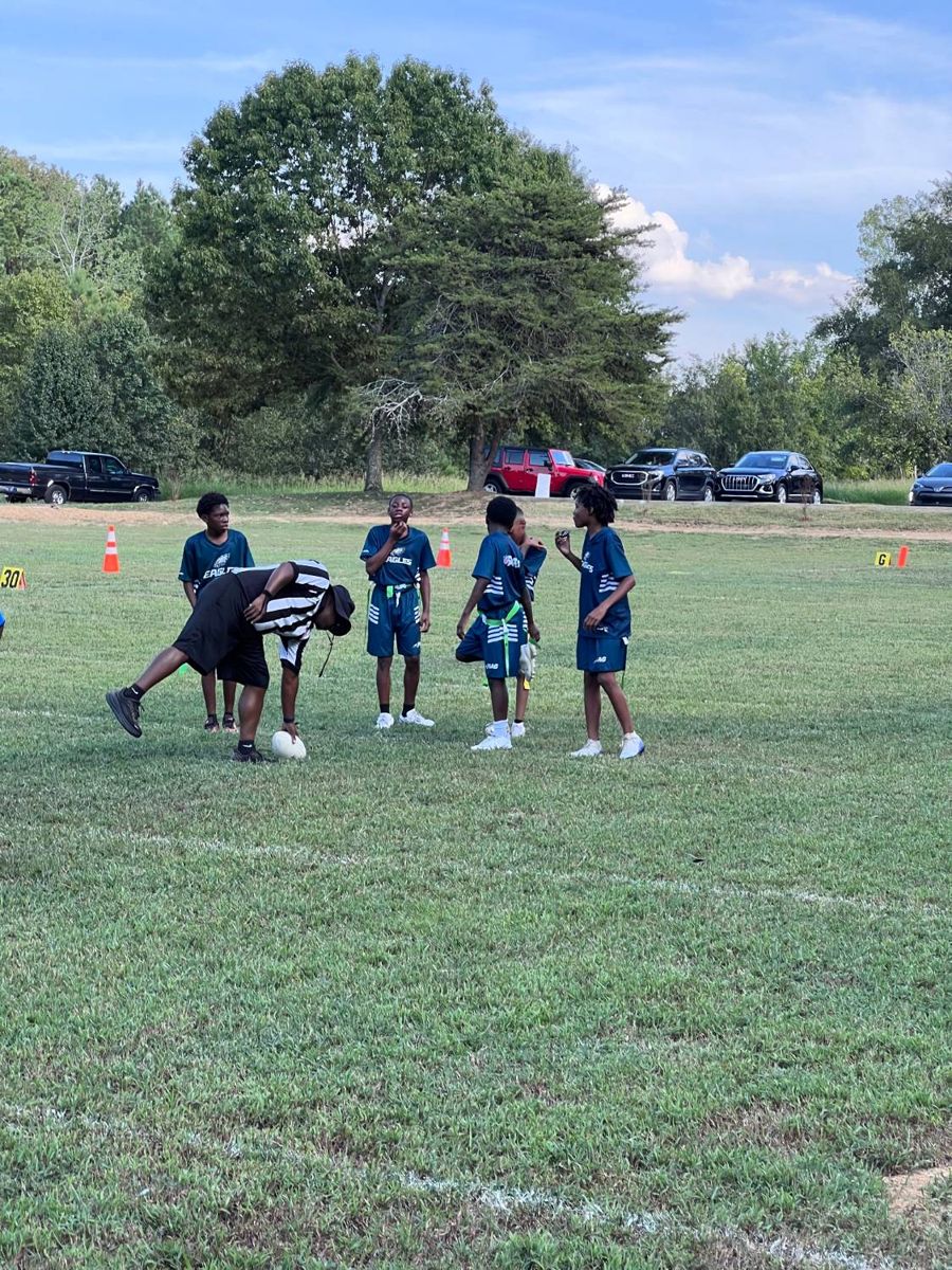 Referee spotting the ball as players line up