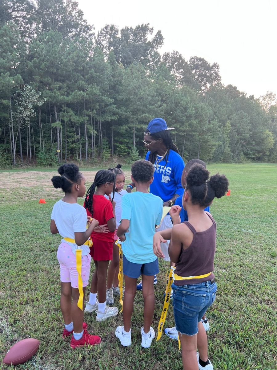 Coach huddled up with young players